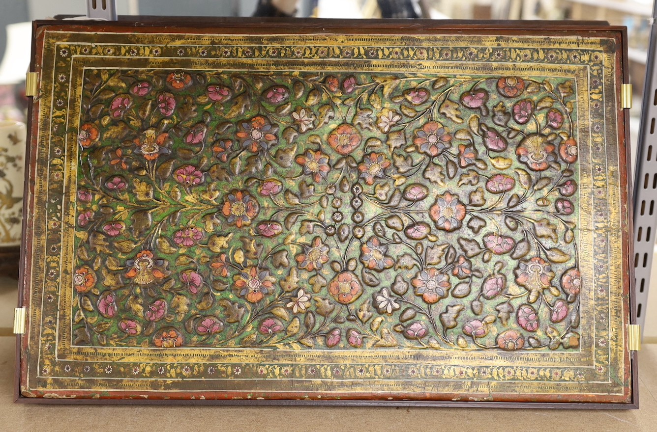 A Persian embossed and painted rectangular plaque, 42.5 cms wide x 62 cms high.